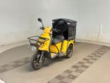 a small yellow motorcycle with a black seat in a garage