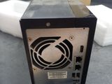 a small computer sitting on a table with a box in the background