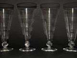 three empty wine glasses are lined up on a black surface