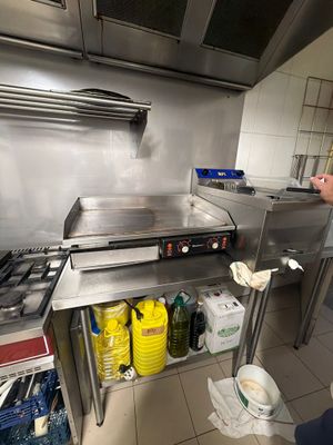 a man that is standing in a kitchen preparing food