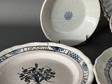three plates and a bowl sitting on a table