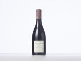 a bottle of red wine sitting on top of a table