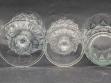 six clear glass plates sitting next to each other on a black surface