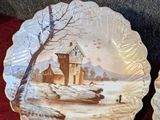 two plates with a picture of a house on them
