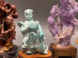 several figurines of different shapes and sizes are displayed on a table