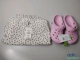 two pairs of shoes and a bag on a table