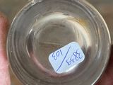 someone is holding a glass of water with a sticker on it