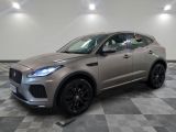 un SUV Jaguar gris garé dans un showroom au sol carrelé
