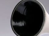 a black and white vase with a white base