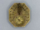an old brass clock with roman numerals on it ' s face