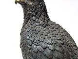 a statue of a bird that is sitting on top of a table