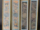four framed art pieces of different colors and designs on a black background