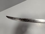 someone is holding a knife in their hand on a table
