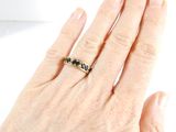 a woman ' s hand with a ring on it
