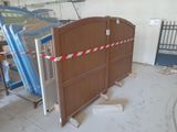 a large wooden gate with a red and white striped tape around it