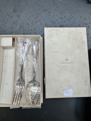 two spoons and a fork in a box on a table