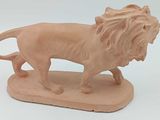 une figurine représentant un lion debout sur un socle