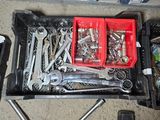 many tools in a tool box on the floor