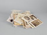 a pile of old photographs sitting on a table