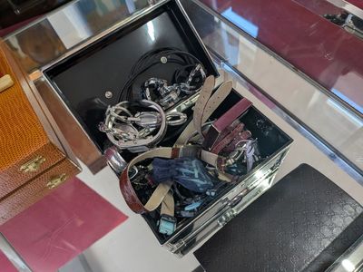 a glass display case with a bunch of jewelry inside of it