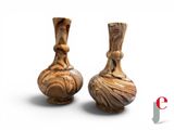 two vases sitting side by side on a white surface