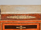 a small chest of drawers with a marble top