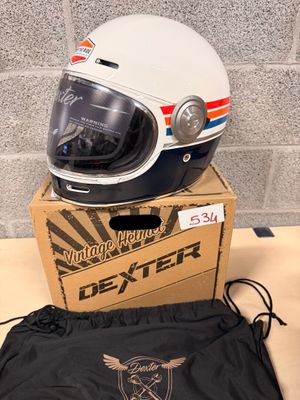 a helmet sitting on top of a box next to a bag
