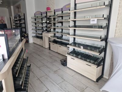many shelves of cosmetics products in a store that is empty