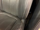 the back seat of a car with a black leather upholstered