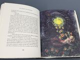 an open book with a picture of flowers on it