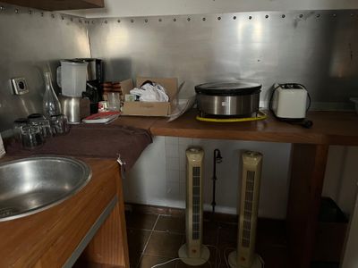 a kitchen with a sink, stove, and other items on the counter