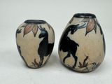 two vases that are decorated with animals on them