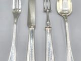 four pieces of silverware including a knife, fork and spoon
