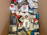 a cardboard box full of electronic devices and other items
