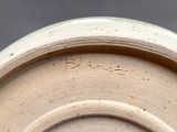 a close up of a white plate with writing on it