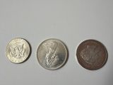 three different types of coins are shown on a white surface
