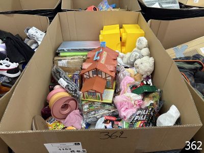 a cardboard box filled with toys and other items