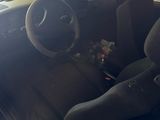 the interior of a car with a dirty seat and steering wheel