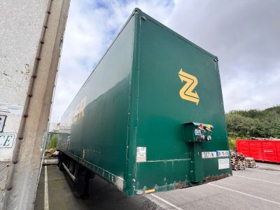 a green semi truck that is parked in a parking lot