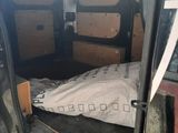 a bed in the back of a van with a mattress on it