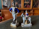 two figurines of a soldier and a dog on a table