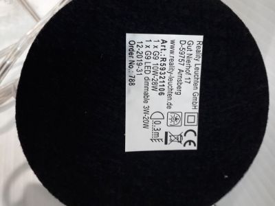a close up of a black round object on a white surface