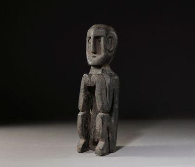 a close up of a statue of a person sitting on a table