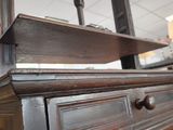 a wooden dresser with a mirror on top of it