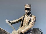 a bronze statue of a man riding a horse