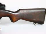 an old rifle with a wooden barrel on a white surface