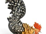 a figurine of a rooster on a glass base