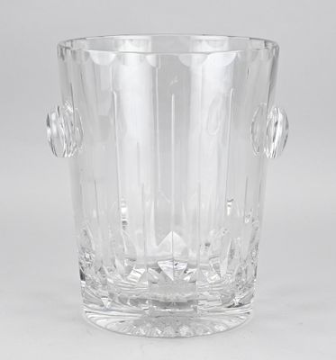 the large clear glass vase is sitting on a white surface