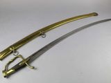a close up of two swords on a white surface