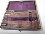 an old purple box with a pair of scissors inside of it